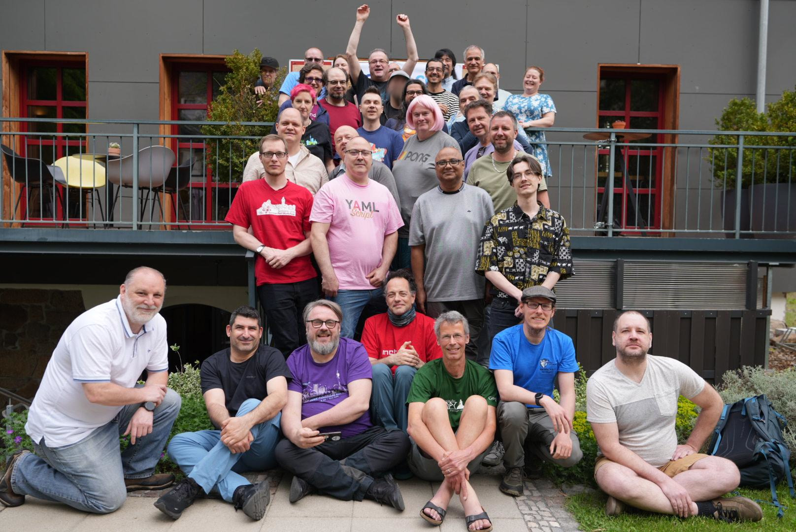A group of really nerdy Perl people, standing on a flight of steps for a group photo
